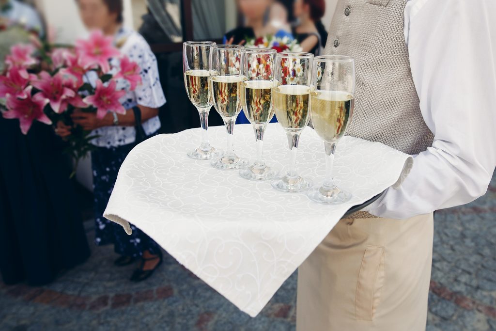 elegant dressed waiter holding tray with champagne 2025 03 16 06 59 05 utc
